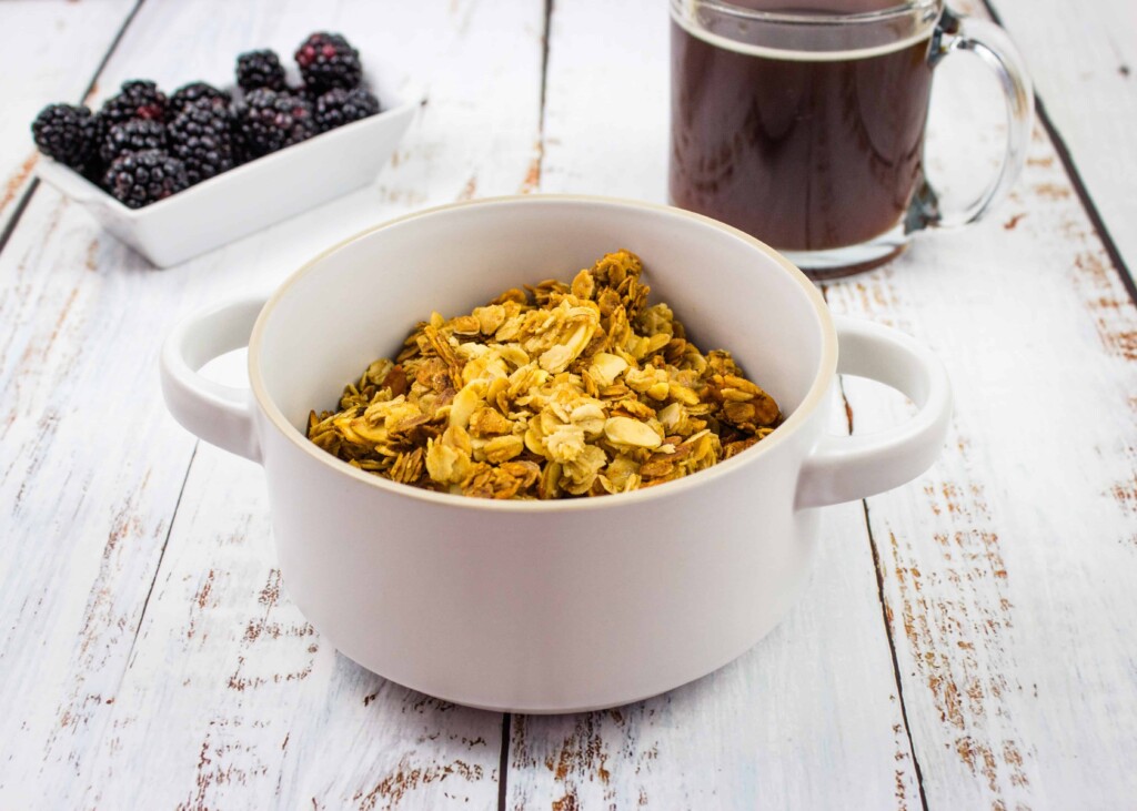 A Bowl of Granola with Blackberries and a Cup of Coffee.