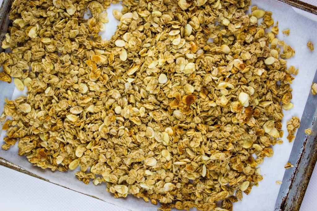 partially baked granola on a sheet pan