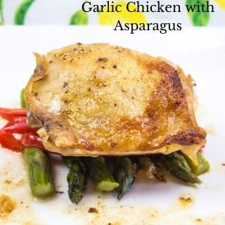 garlic chicken with asparagus on a square white plate