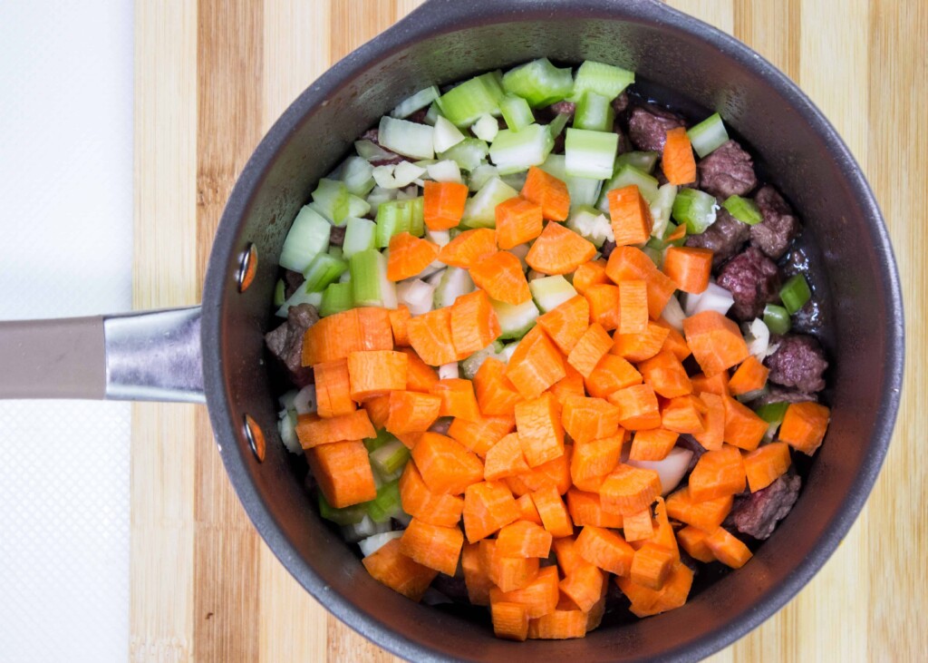 Carrots, celery and onion added to the beef in the pot.