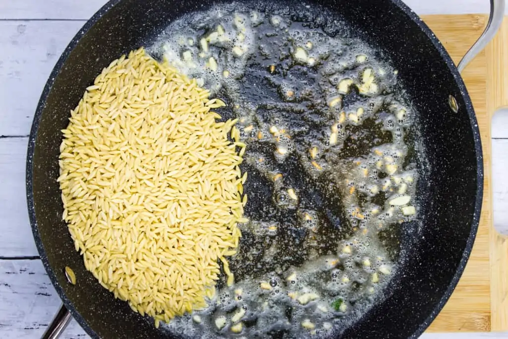 toasting the orzo in the skillet with the garlic butter