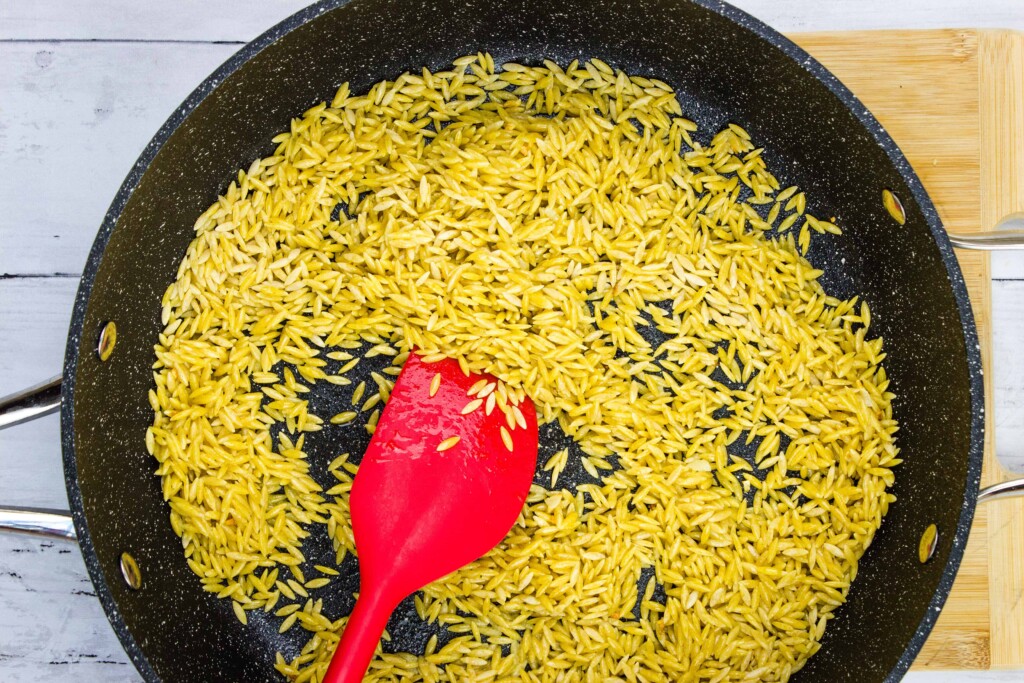 golden brown orzo in the skillet