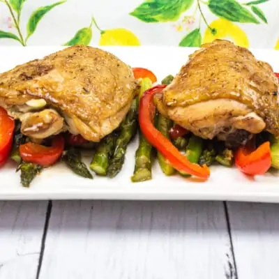 garlic chicken and asparagus on a white plate