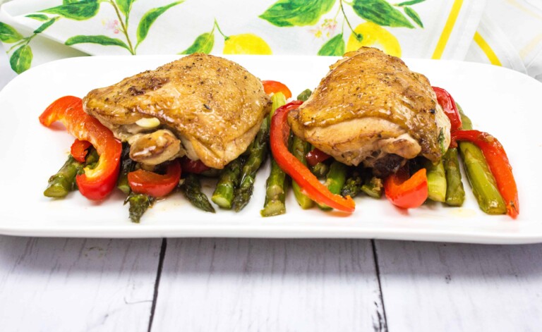 garlic chicken and asparagus on a white plate