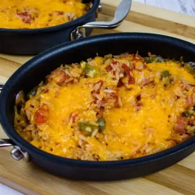 baked cheesy spanish rice in a small oval casserole dish