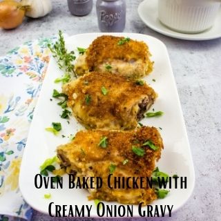 oven roasted chicken thighs on a platter with a gravy boat in the background