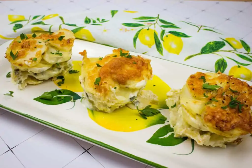 potatoes au gratin gruyere on a platter with a floral napkin