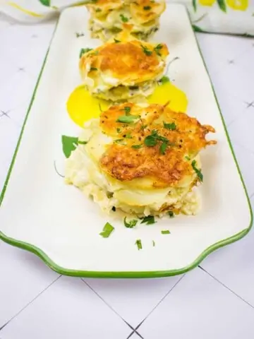 potatoes au gratin gruyere on a platter with a floral napkin