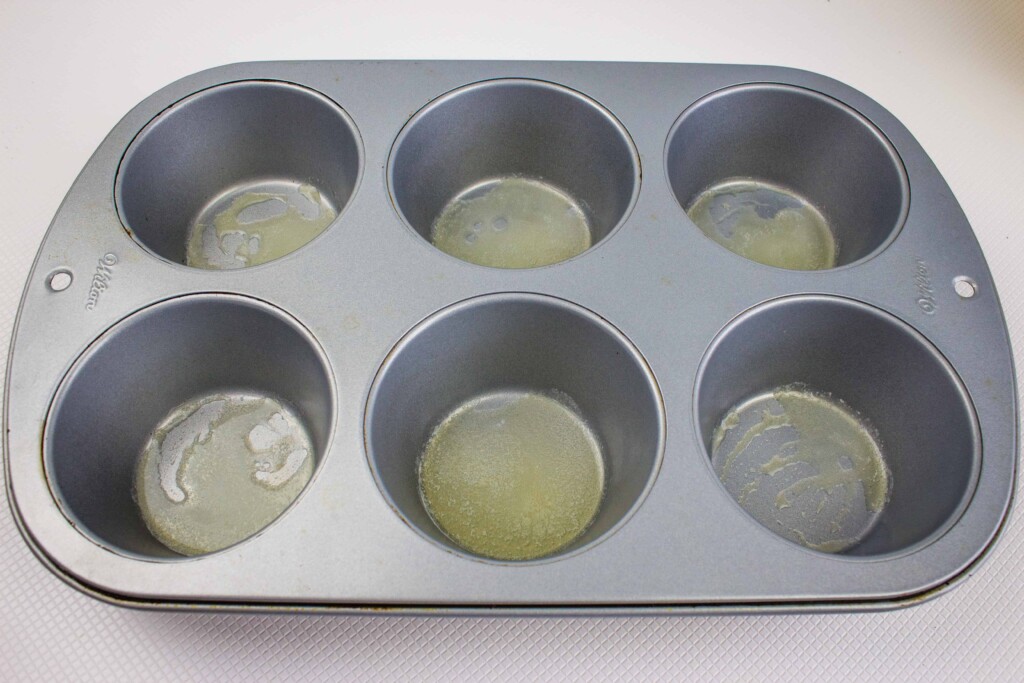 melted butter in the muffin cups
