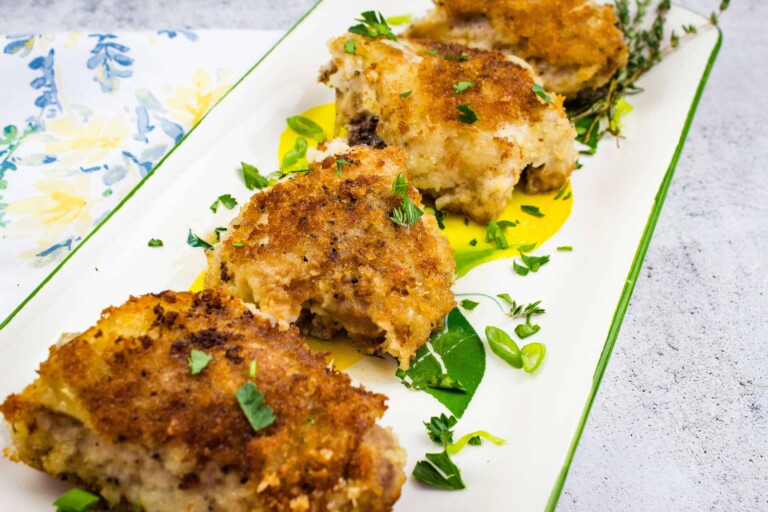 Oven baked chicken with creamy onion gravy on a platter
