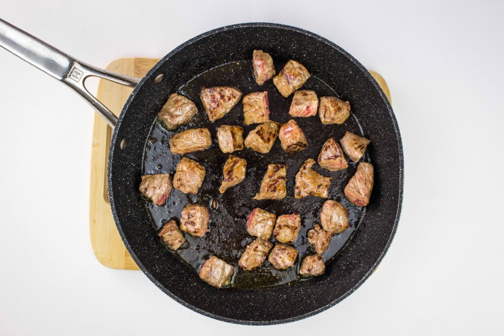 browning the seasoned beef in a skillet