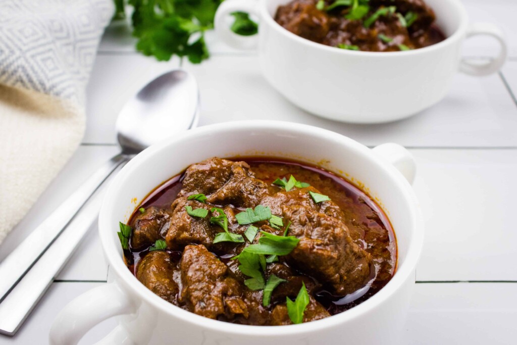 Authentic Hungarian Goulash in a white bowl.