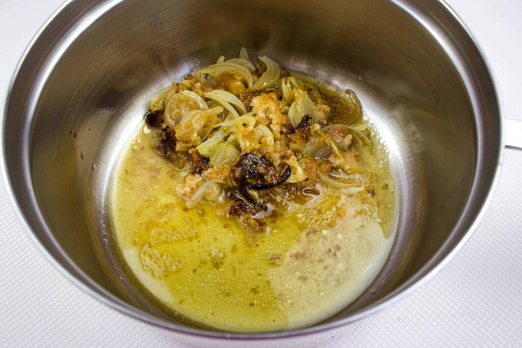 scrape all the drippings and chunks from the baking dish into a pot