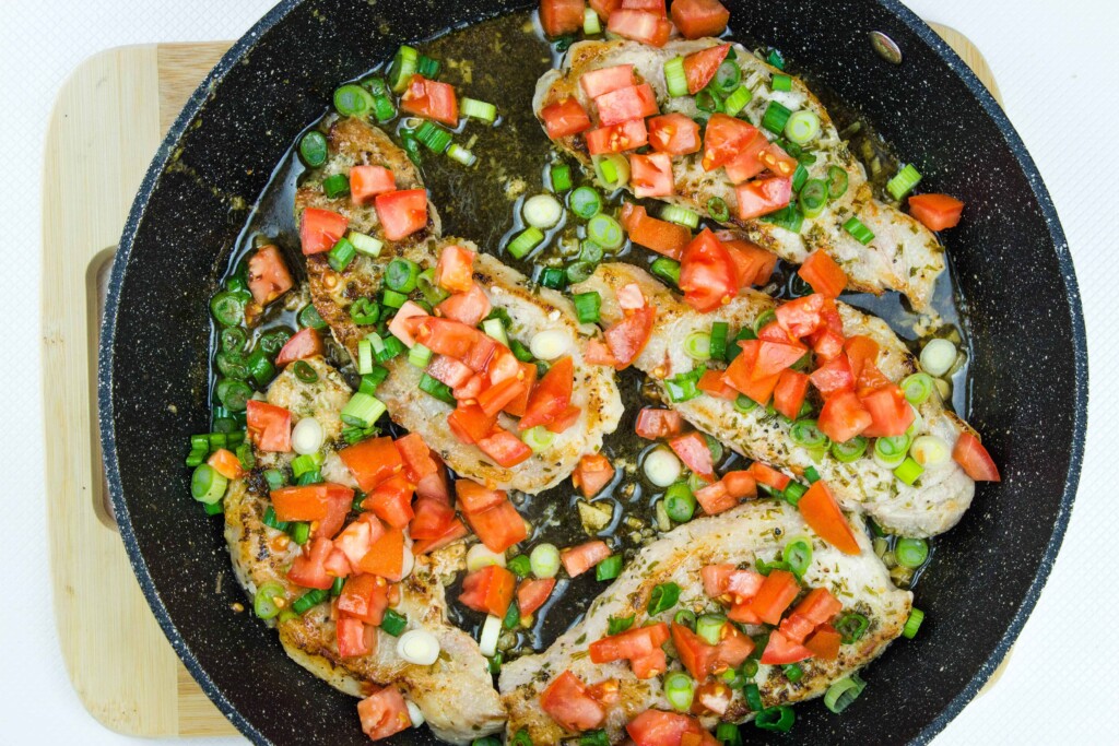 the cooked pork chops topped with tomato and onion relish