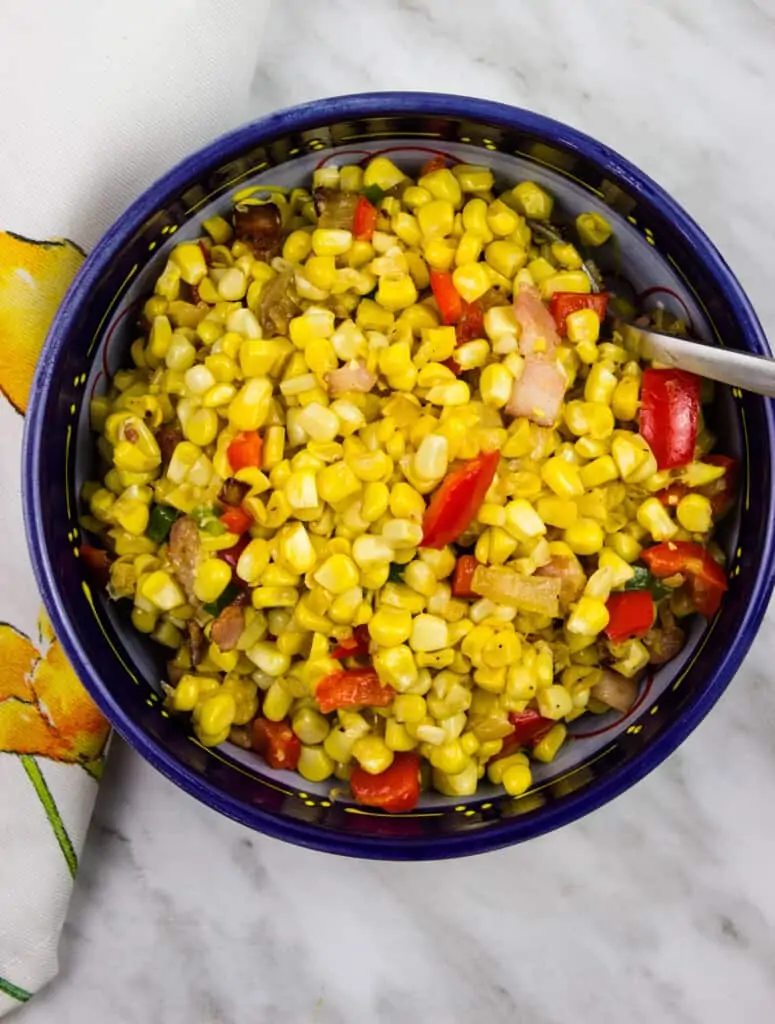 texas corn succotash in a dark blue serving bowl