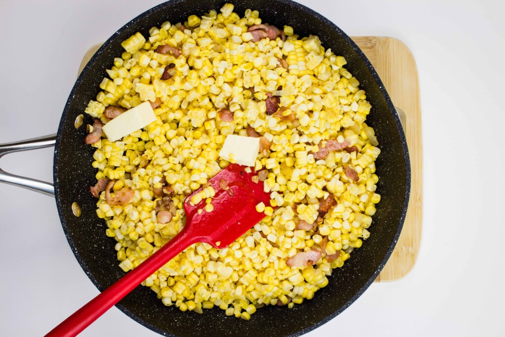 adding the butter and corn to the pan