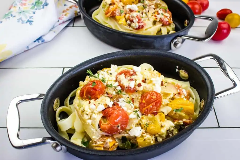 baked feta pasta in an oval black dish with a second in the background