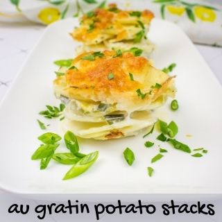 au gratin potato stacks on a white serving platter