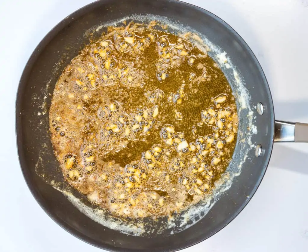 adding lemon juice and zest to the sauce in a skillet