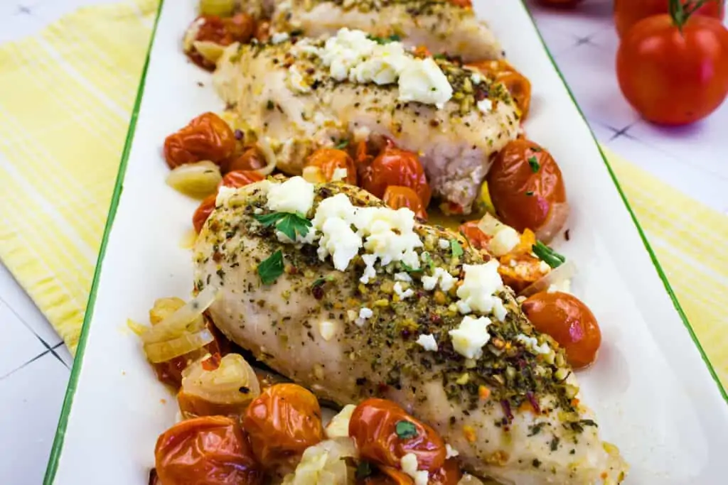 a closeup of mediterranean chicken bake with feta and tomatoes