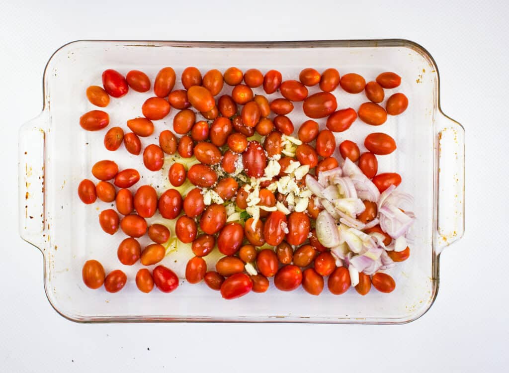 Mixing tomatoes, shallot, garlic, and olive oil.