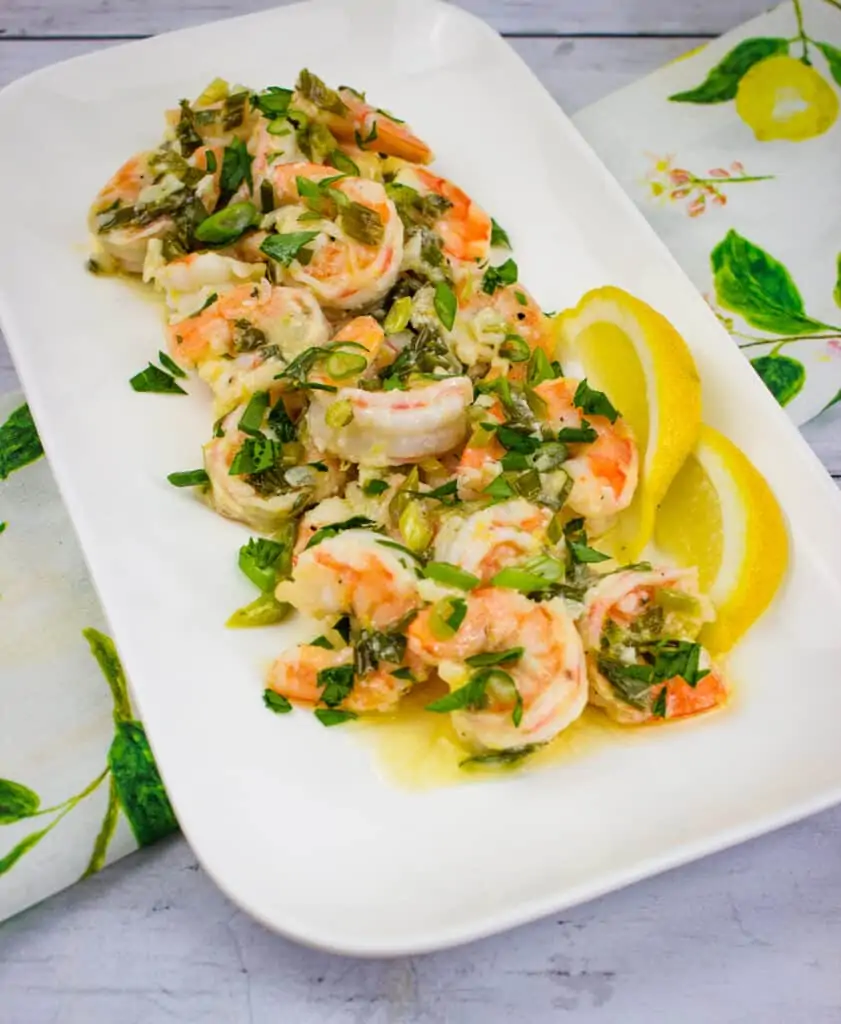 Garlic Shrimp Scampi with lemon slices on a white platter.