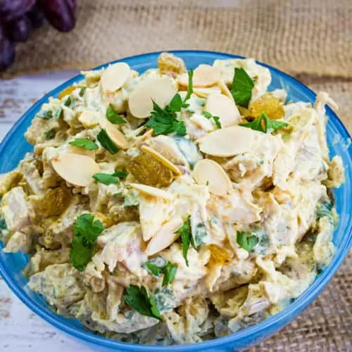 curried chicken salad with raisins in a serving bowl