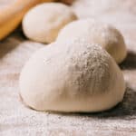 pizza dough balls on a countertop