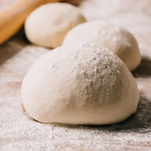 pizza dough balls on a countertop