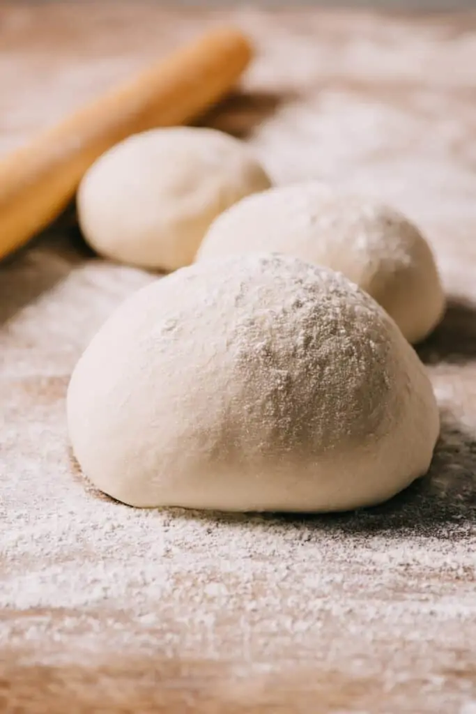 pizza dough balls on a countertop