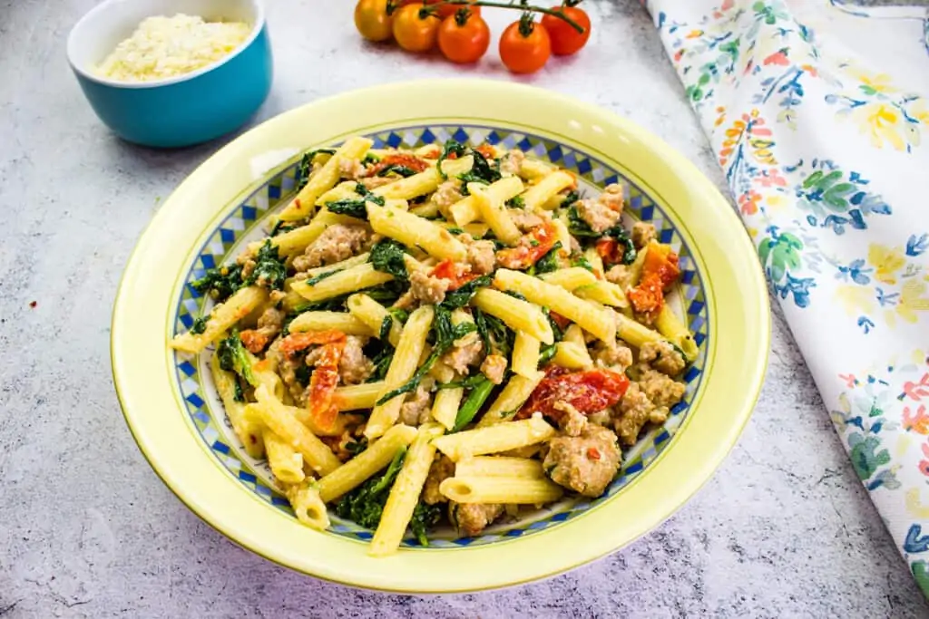 broccoli rabe with sausage pasta in a serving bowl