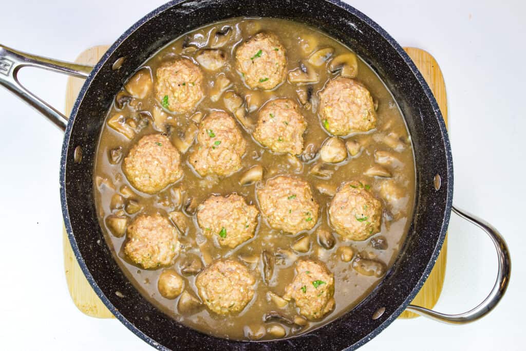Add the broth and simmer, then add meatballs.