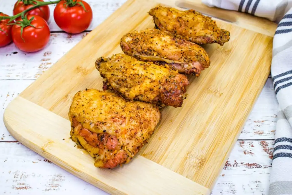 smoked chicken thighs on a cutting board