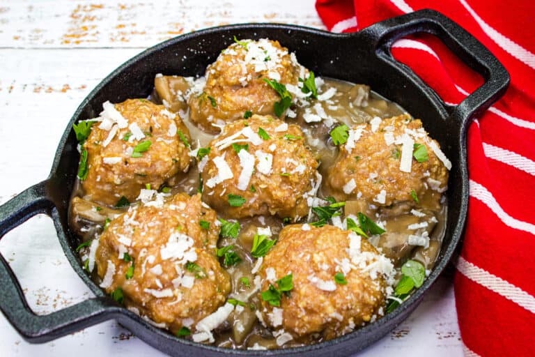 Chicken marsala meatballs in a cast iron skillet.