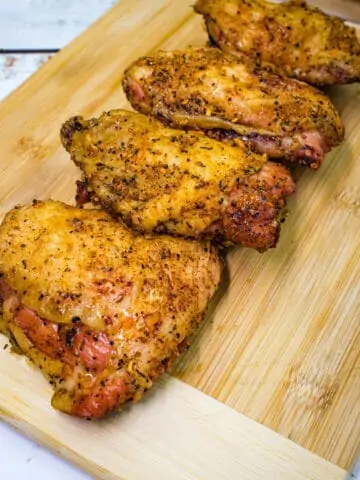 smoked chicken thighs on a cutting board