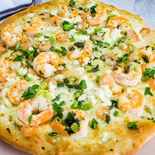 A shrimp scampi pizza loaded with melted cheese.