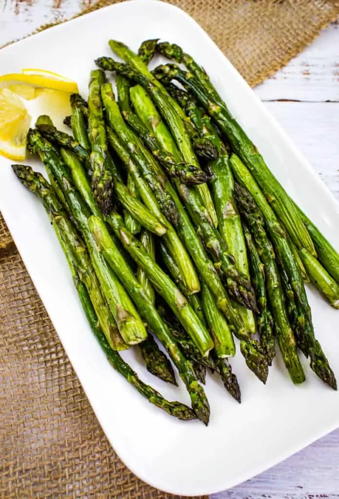 smoked asparagus on a white serving plate