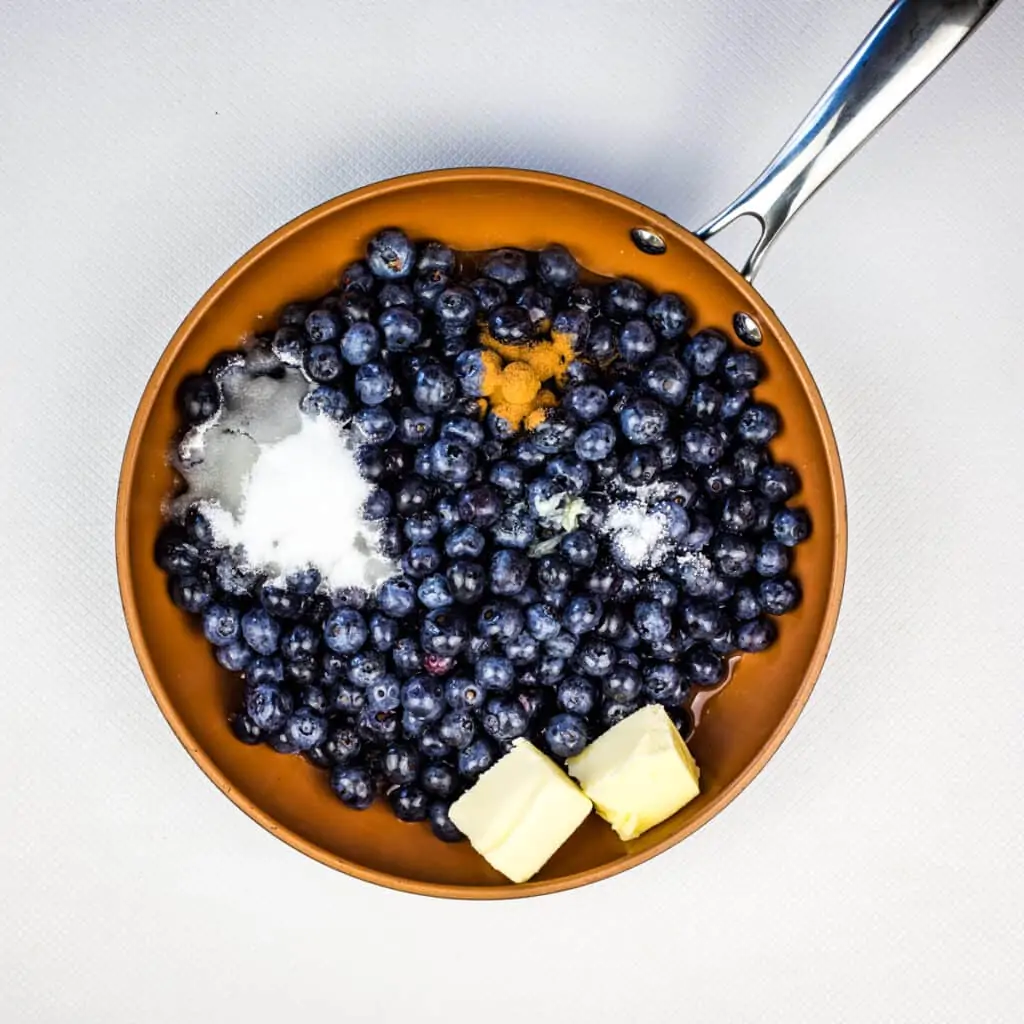 cooking the blueberries with water, sugar, lemon and butter