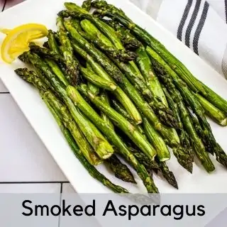 smoked asparagus on a white platter.