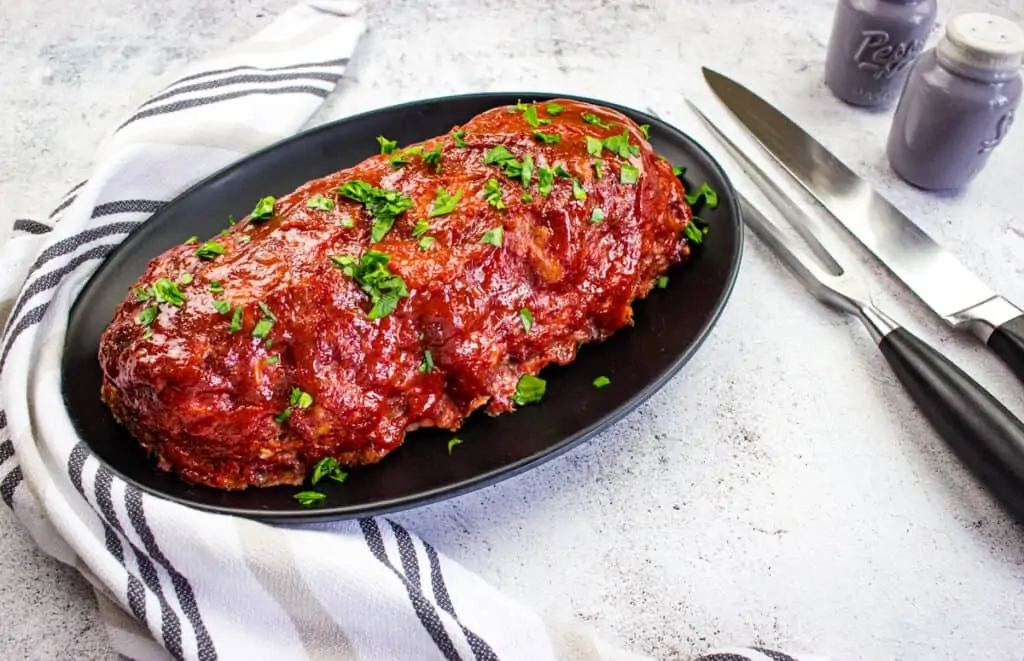 smoked meatloaf recipe on a black plate