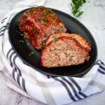 smoked meatloaf on a black plate