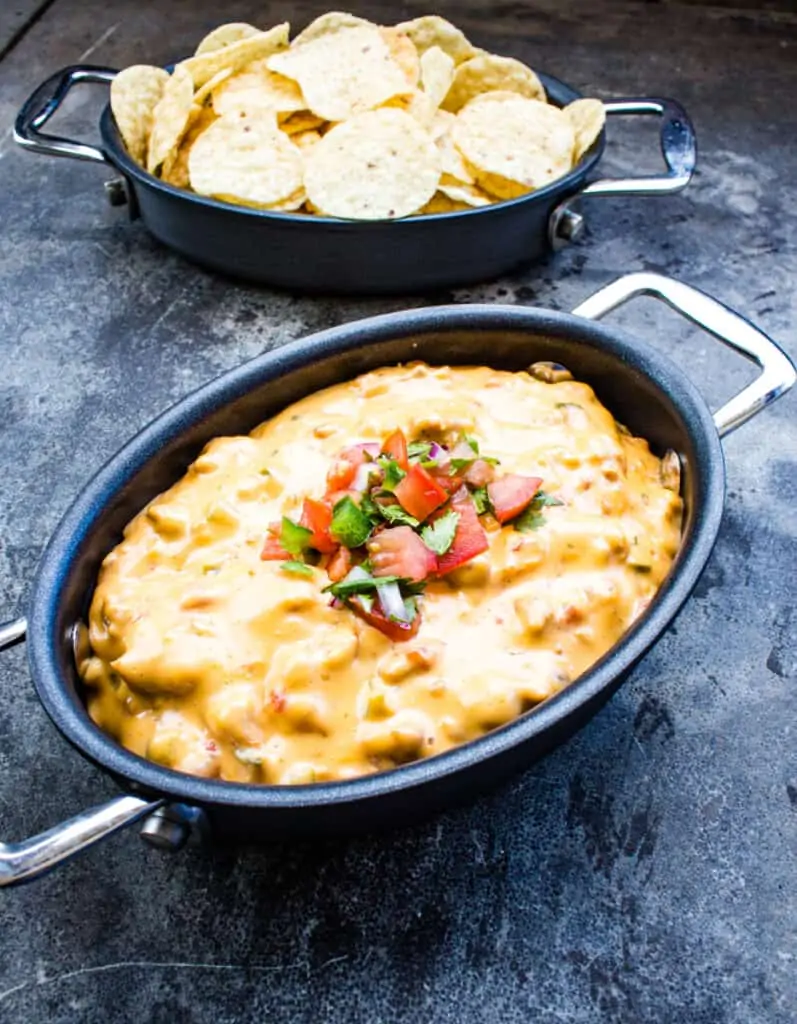 smoked queso in a black dish with chips in the background