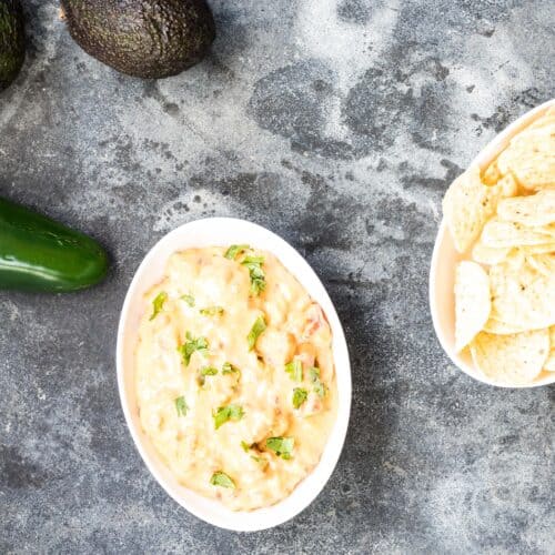 Smoked queso in a small white dish with tortilla chips.