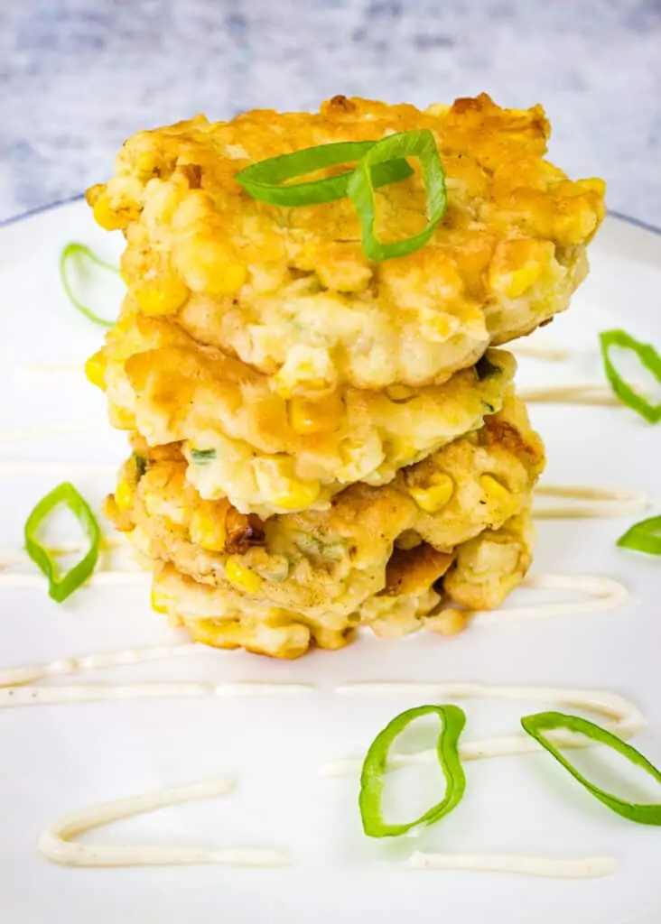 corn fritters with jalapeno and applewood smoked cheddar in a stack