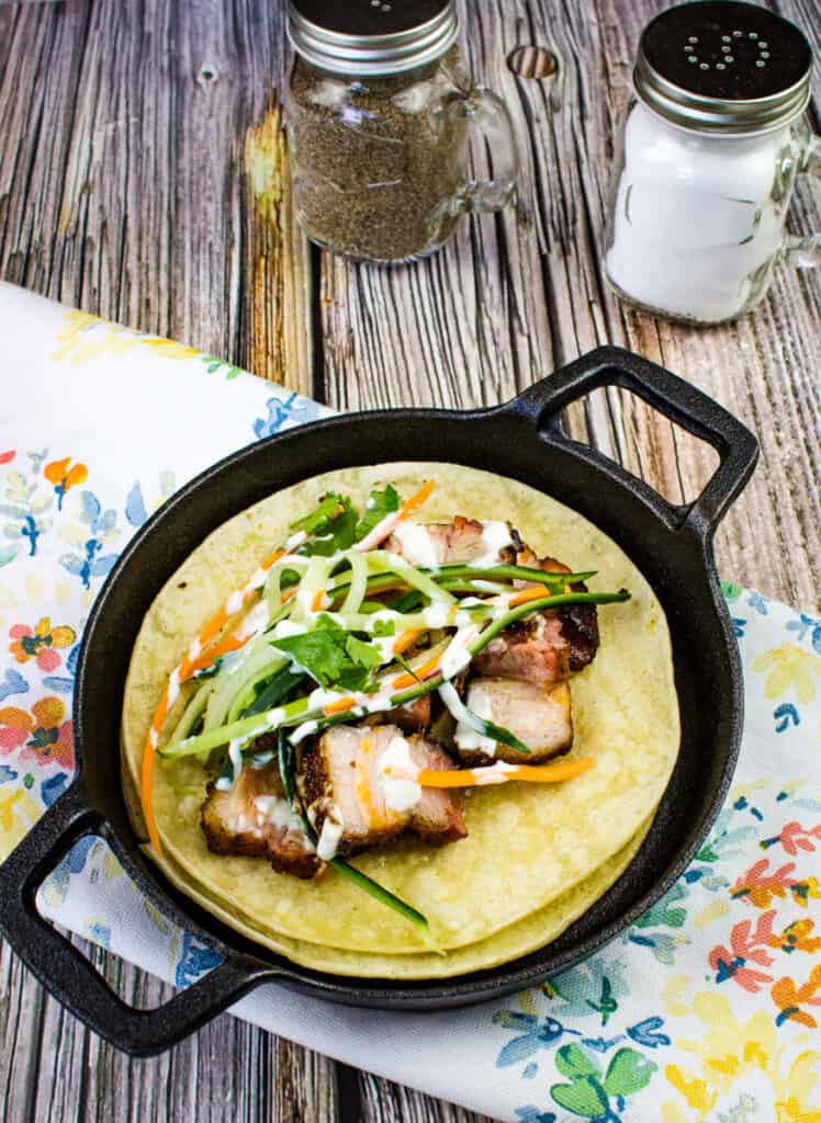 smoked pork belly tacos in a black pan