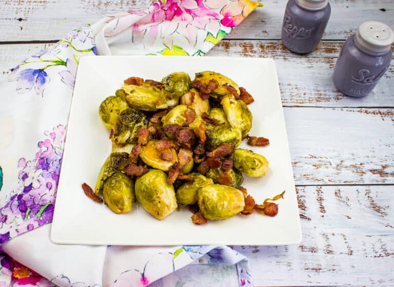 Smoked brussels sprouts on a white plate.