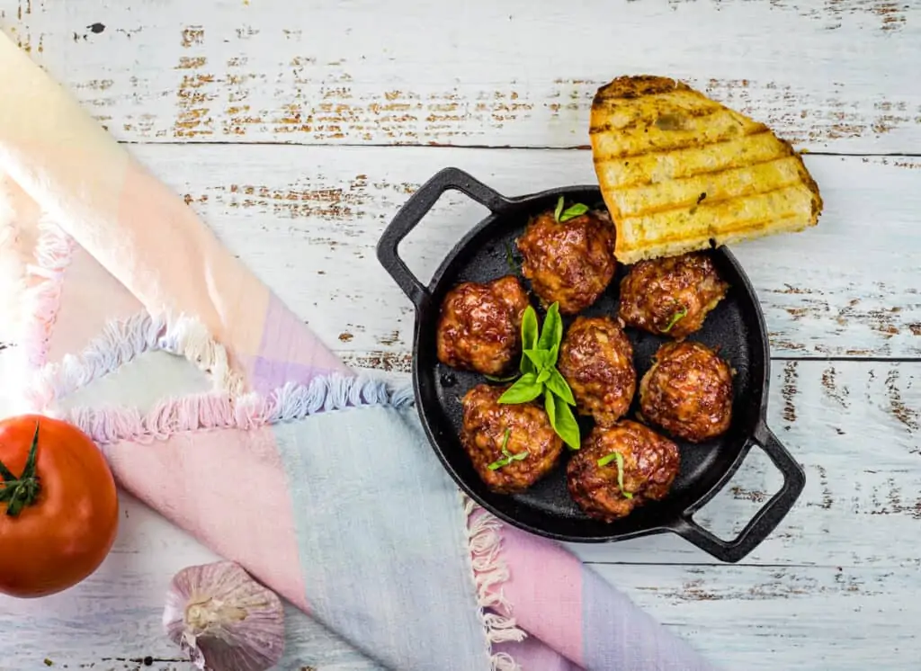 smoked meatballs in a dish with grilled bread