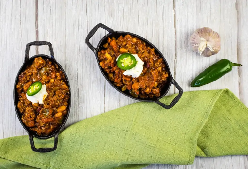 over the top chili in black cast iron pans