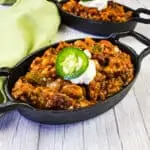 Over the top chili in black cast iron pans