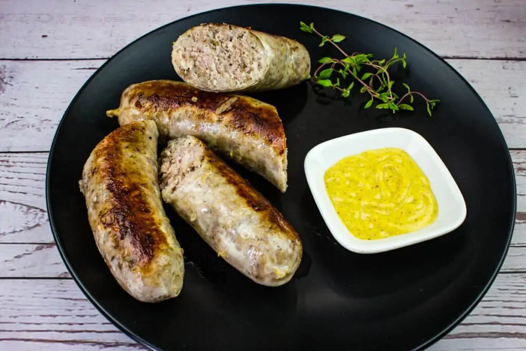 sausage sous vide on a plate with mustard